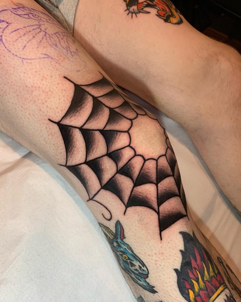traditional spider web elbow tattoos